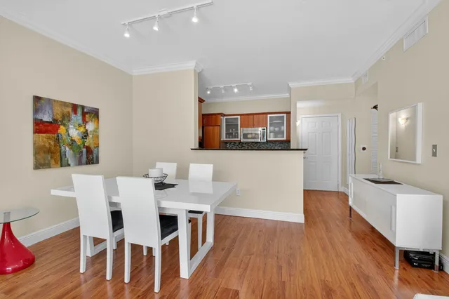 a view of a dining room with furniture and wooden floor