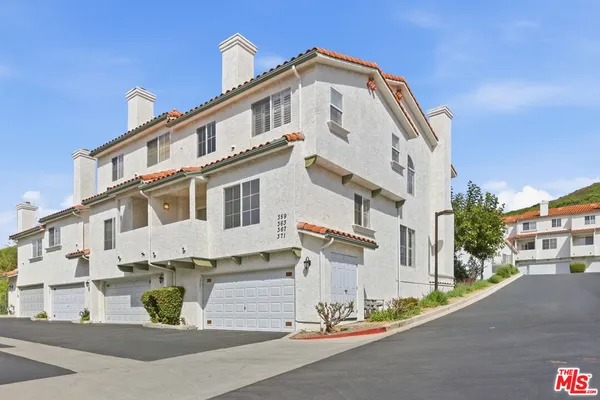 a view of a white building among the street