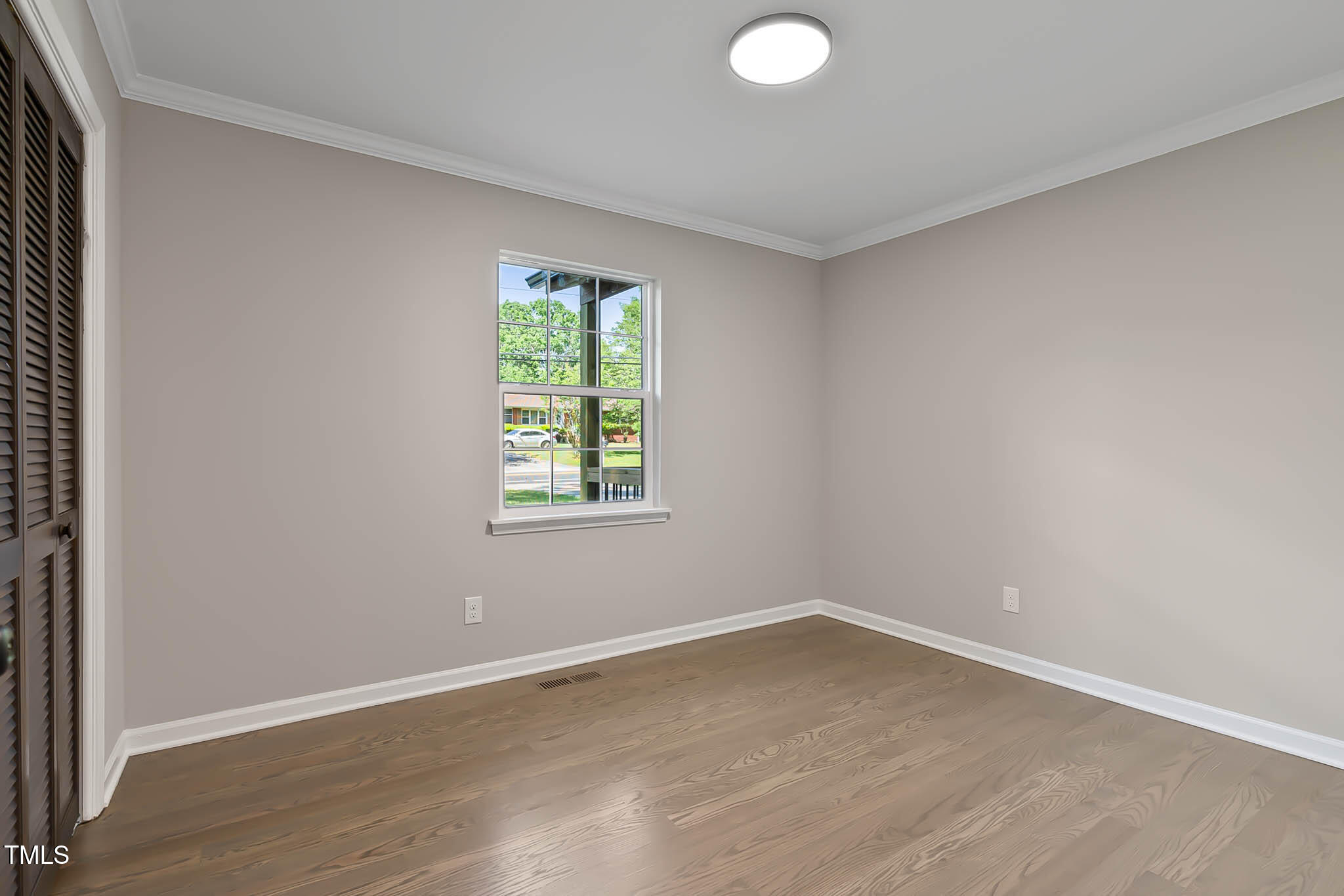 2704 Ross Road Durham, NC 27703 - Photo 17 of 28 an empty room with wooden floor and windows