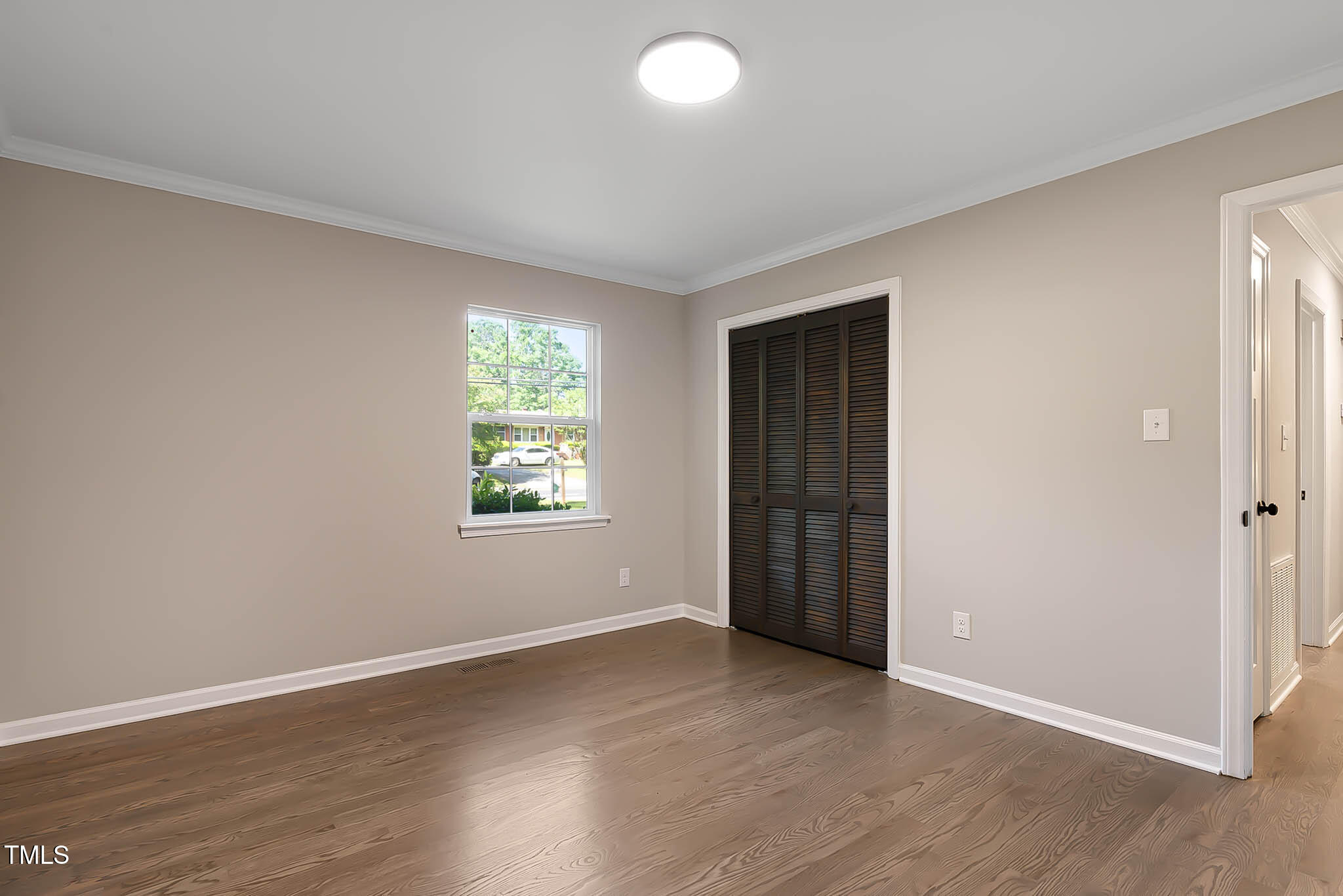 2704 Ross Road Durham, NC 27703 - Photo 18 of 28 an empty room with wooden floor and windows