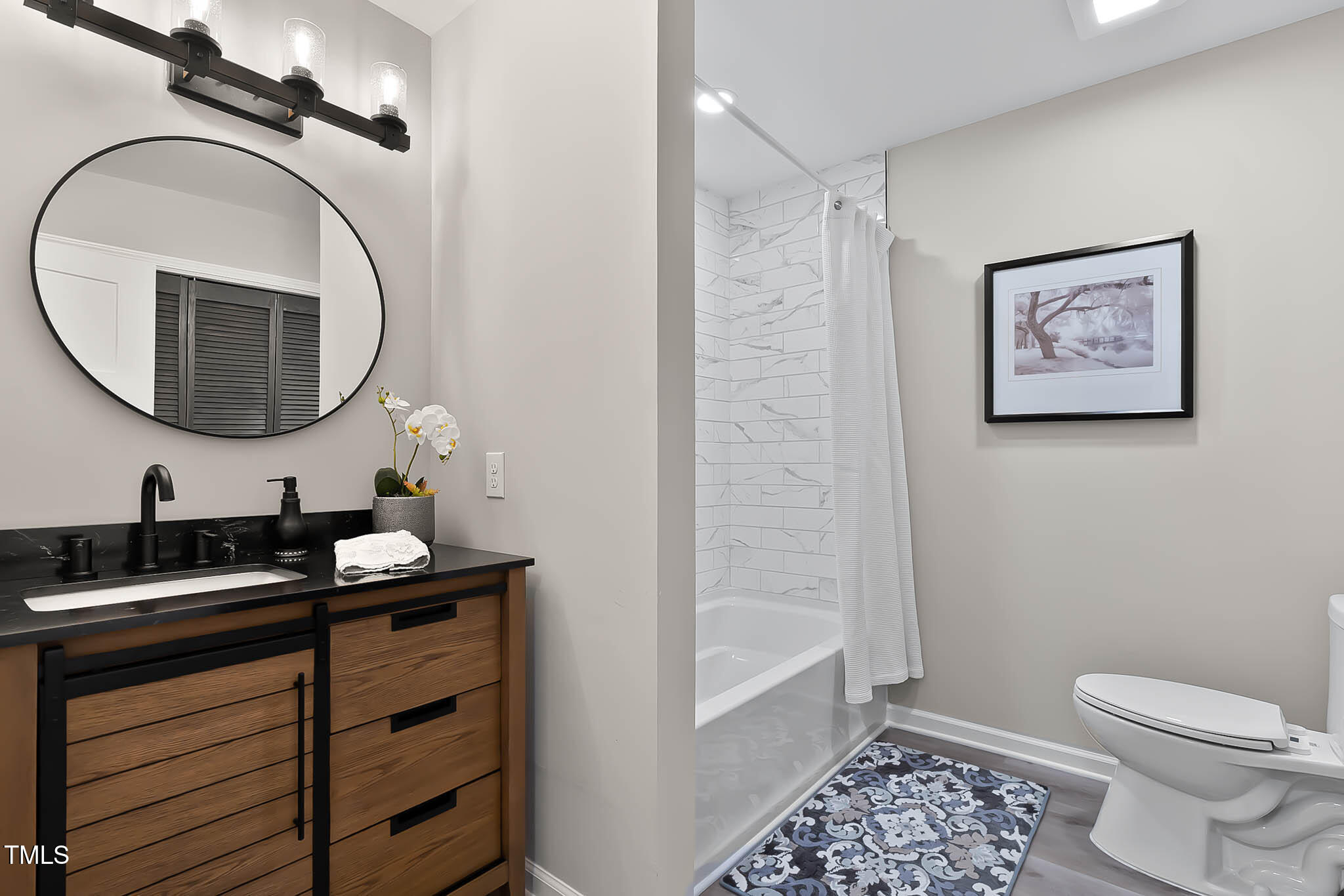2704 Ross Road Durham, NC 27703 - Photo 19 of 28 a bathroom with a sink a toilet and a mirror