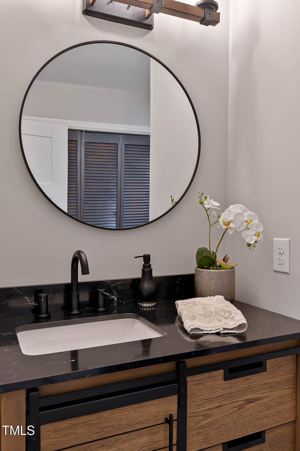 2704 Ross Road Durham, NC 27703 - Photo 20 of 28 a bathroom with a sink and a mirror
