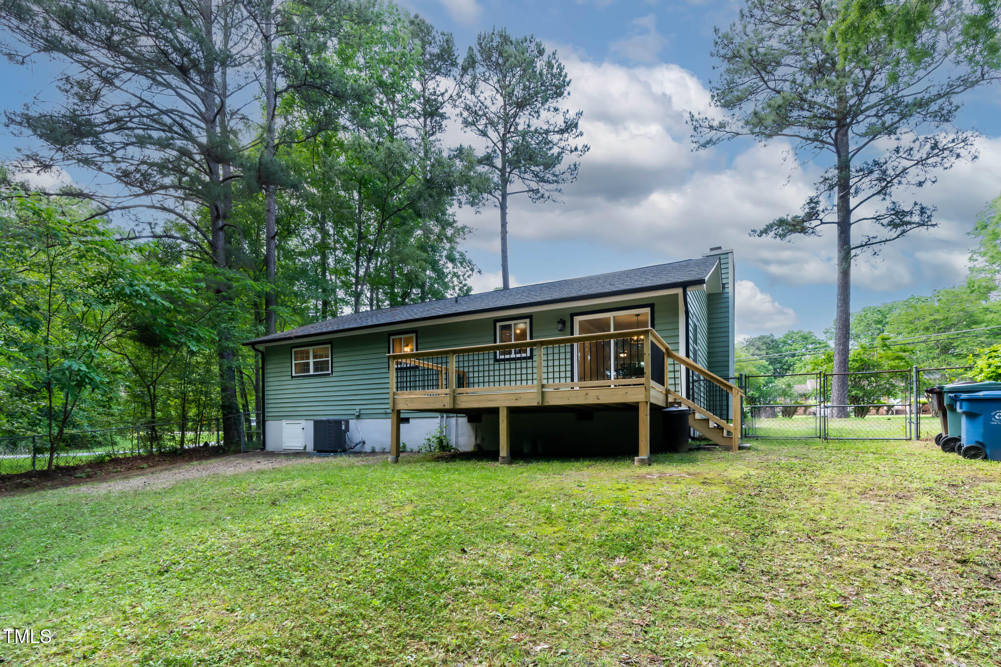 2704 Ross Road Durham, NC 27703 - Photo 23 of 28 a front view of a house with a garden and trees