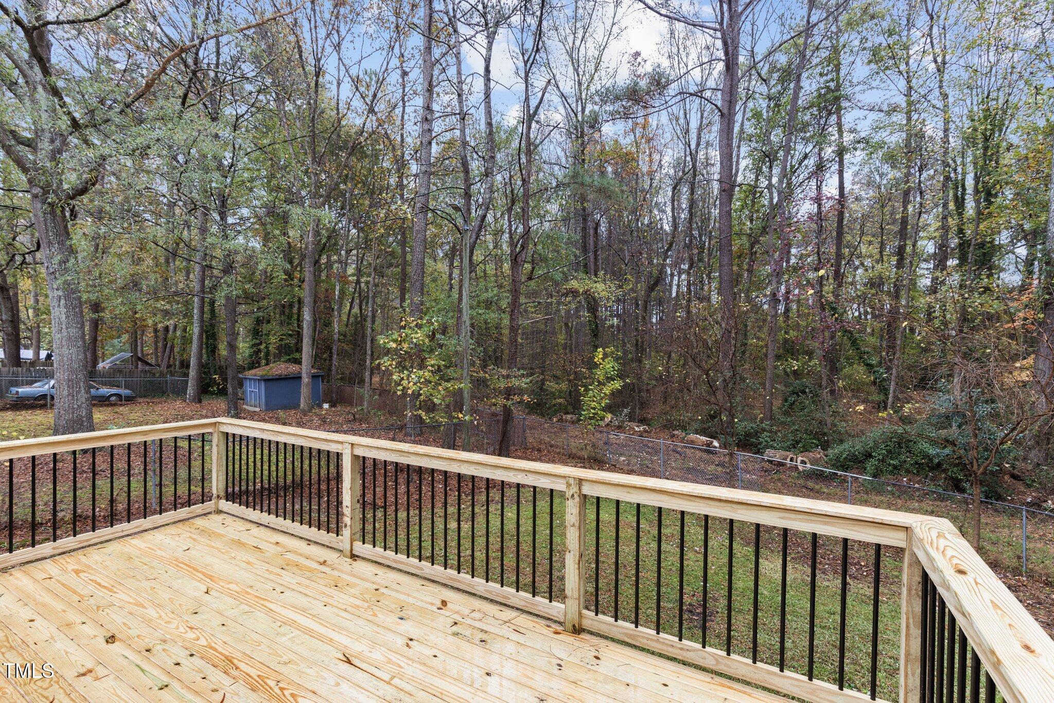 2704 Ross Road Durham, NC 27703 - Photo 25 of 28 a view of a wooden deck with large trees
