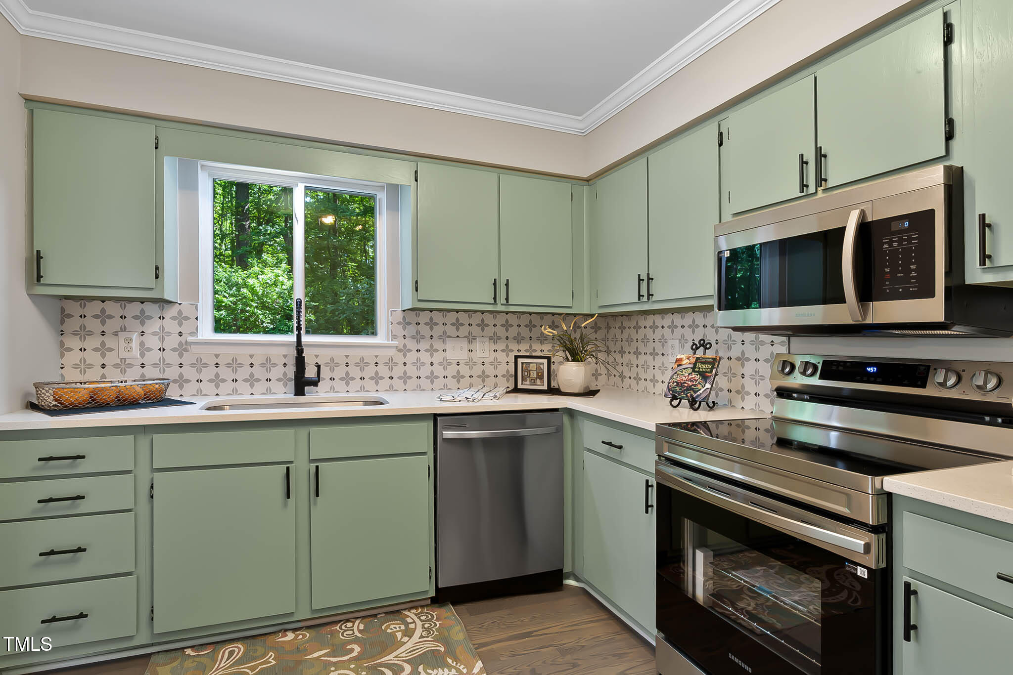 2704 Ross Road Durham, NC 27703 - Photo 10 of 28 a kitchen with stainless steel appliances granite countertop a sink stove and microwave