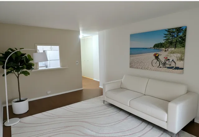 a living room with furniture and a potted plant