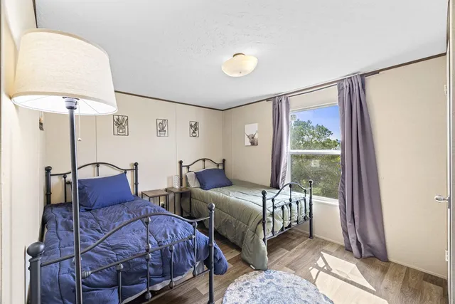 a bedroom with double bed and a window