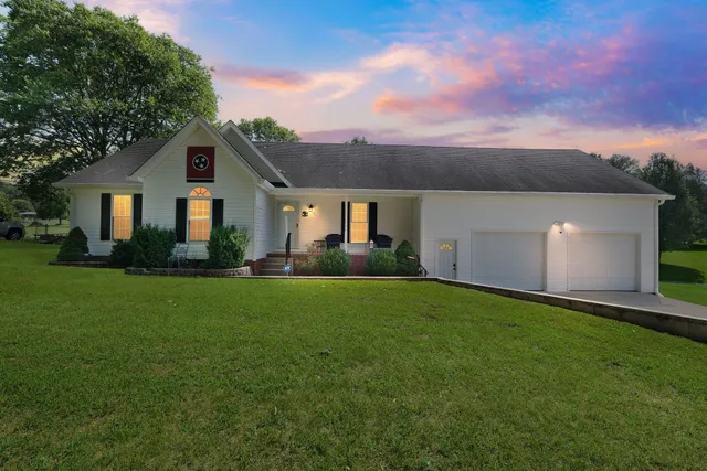 a front view of house with yard and green space