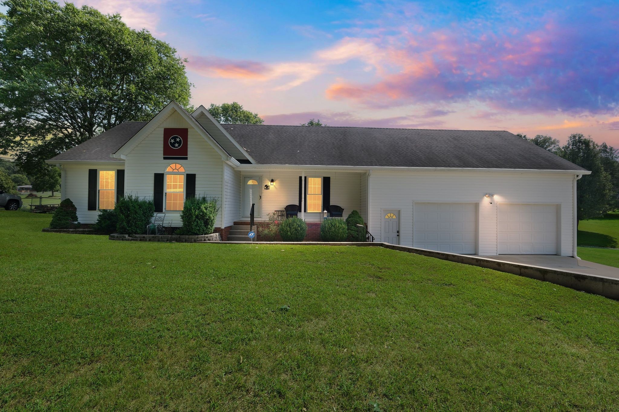 a front view of house with yard and green space