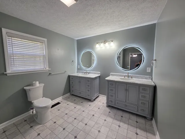 a view of a livingroom with a ceiling fan and window