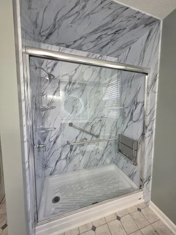 an empty room with windows and ceiling fan