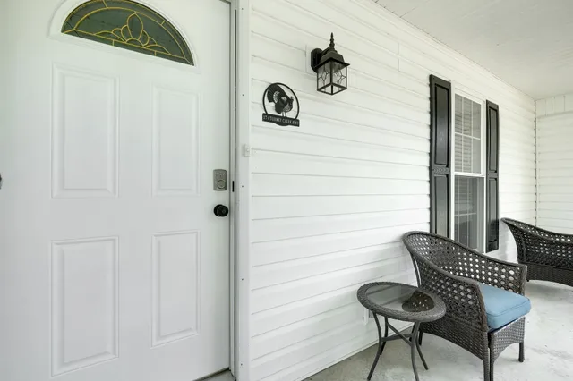 a view of wooden door and chair in a room
