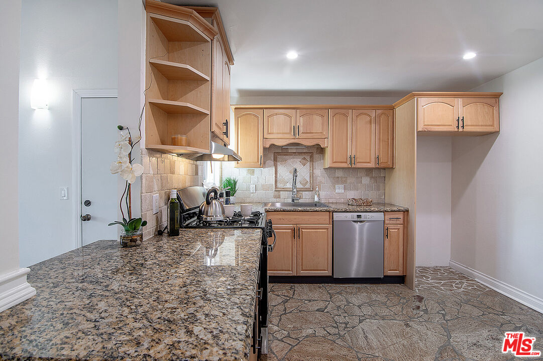 4925 Indian Wood Road, Unit 474 Culver City, CA 90230 - Photo 12 of 36 a kitchen with stainless steel appliances granite countertop a sink stove and cabinets