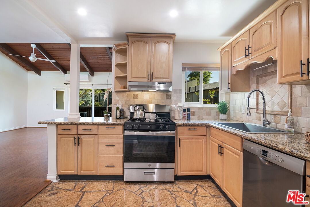 4925 Indian Wood Road, Unit 474 Culver City, CA 90230 - Photo 13 of 36 a kitchen with stainless steel appliances granite countertop a stove a sink and a microwave