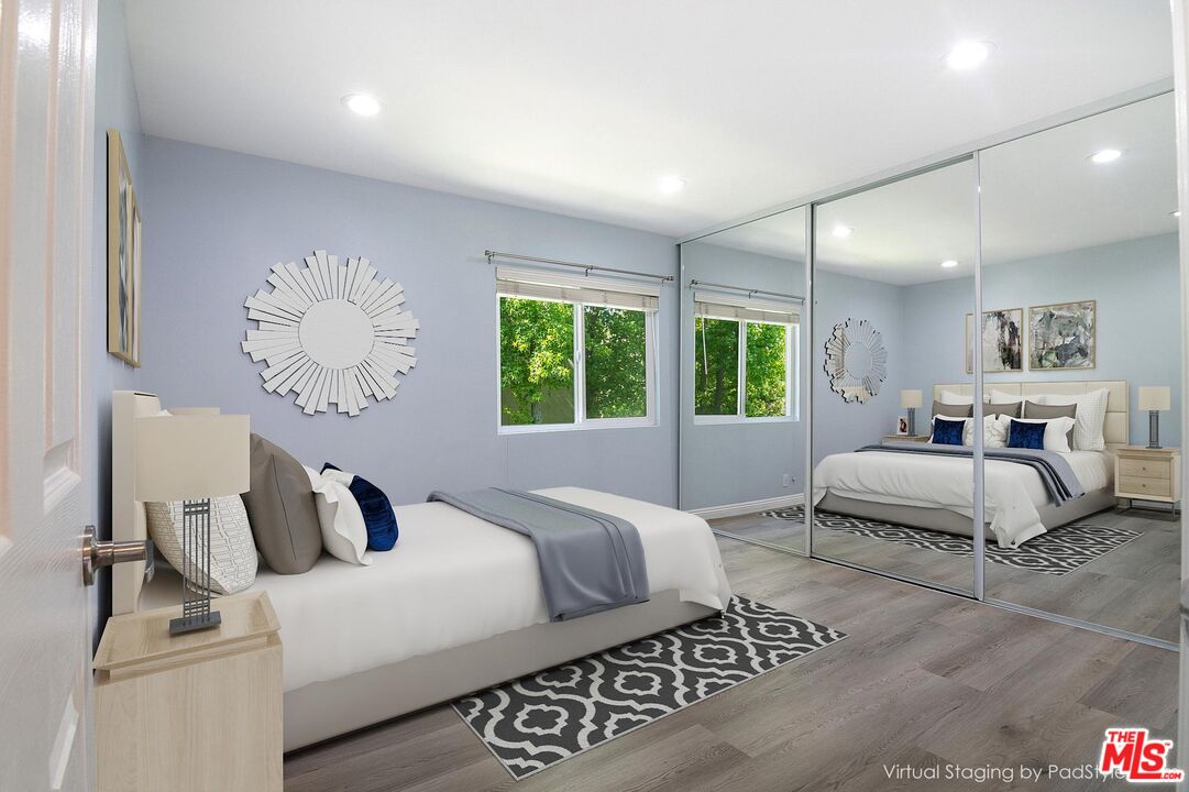 4925 Indian Wood Road, Unit 474 Culver City, CA 90230 - Photo 14 of 36 a bedroom with a large bed and a chandelier
