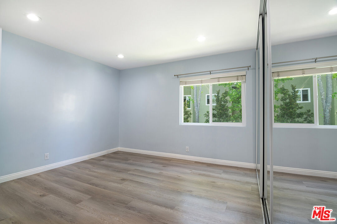 4925 Indian Wood Road, Unit 474 Culver City, CA 90230 - Photo 15 of 36 an empty room with wooden floor and windows