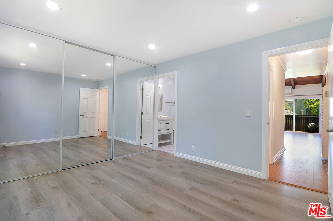 4925 Indian Wood Road, Unit 474 Culver City, CA 90230 - Photo 16 of 36 an empty room with wooden floor and windows