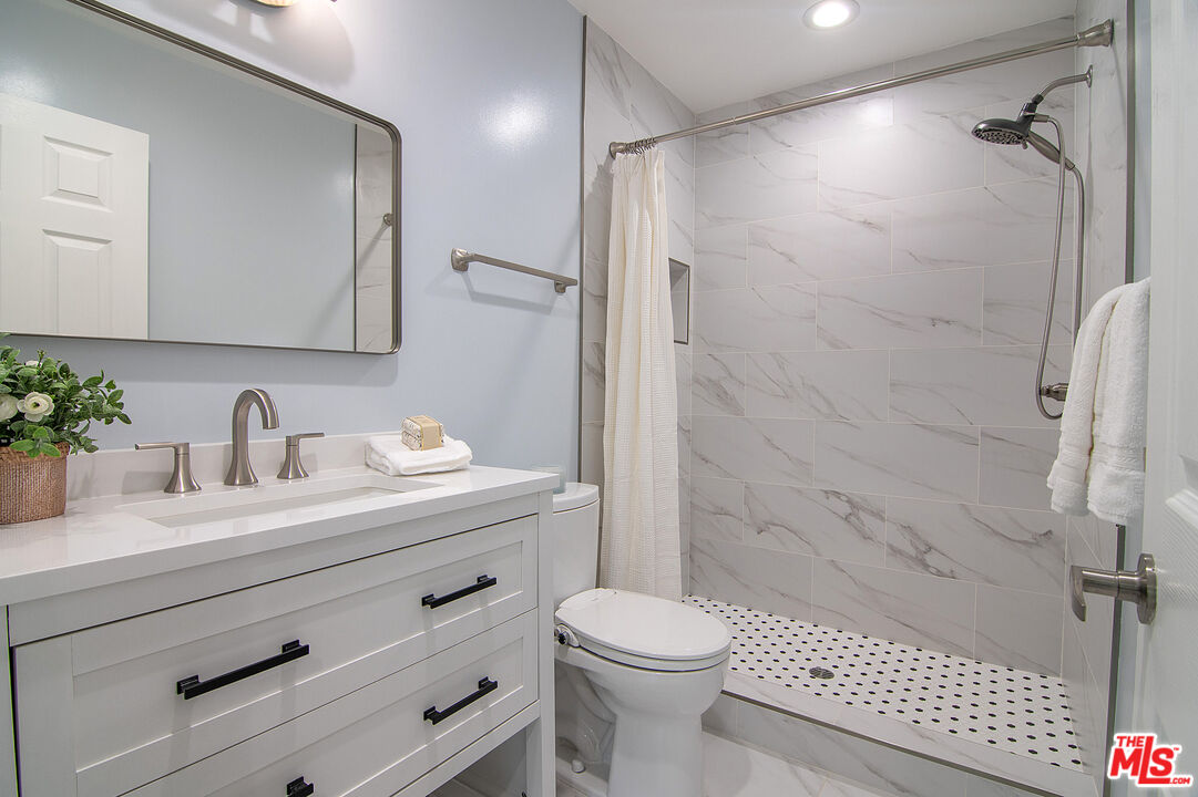 4925 Indian Wood Road, Unit 474 Culver City, CA 90230 - Photo 17 of 36 a bathroom with a sink a toilet and shower