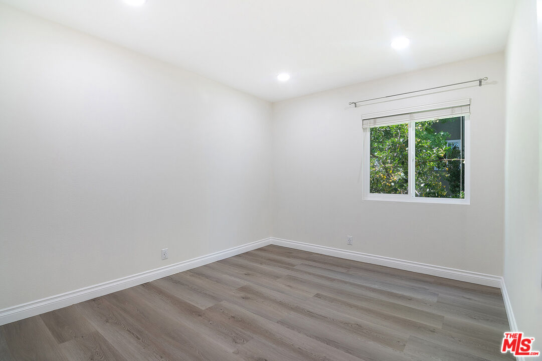4925 Indian Wood Road, Unit 474 Culver City, CA 90230 - Photo 19 of 36 an empty room with wooden floor and windows