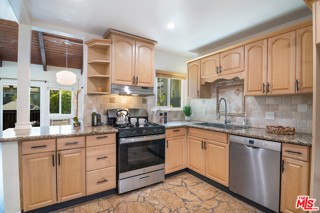 4925 Indian Wood Road, Unit 474 Culver City, CA 90230 - Photo 2 of 36 a kitchen with stainless steel appliances granite countertop a sink and cabinets