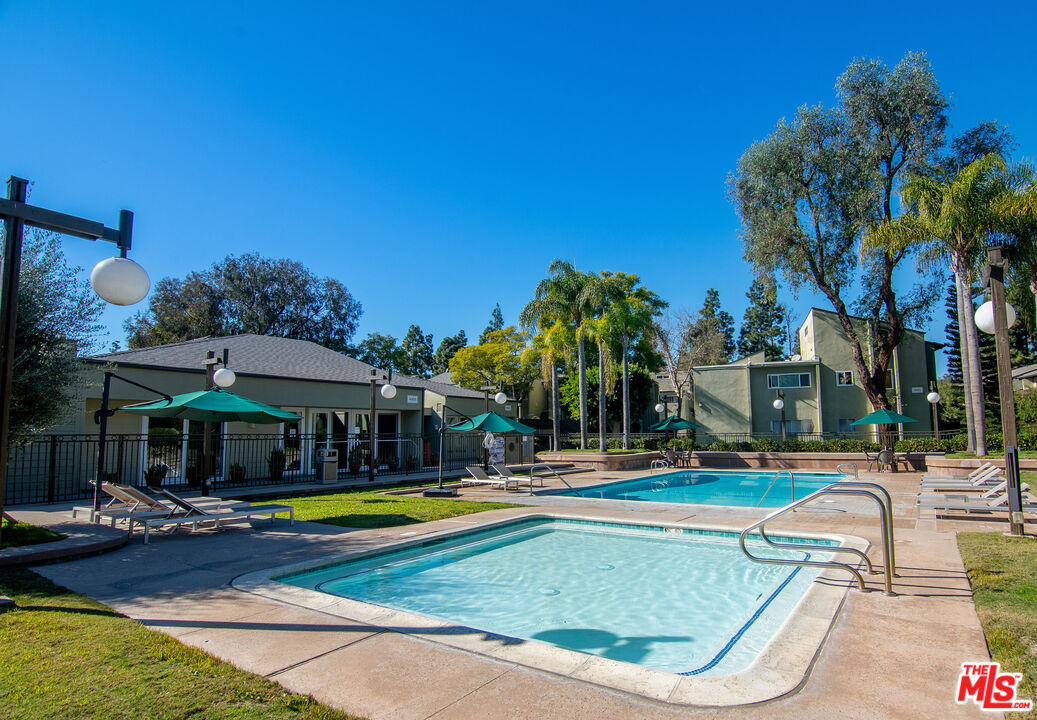 4925 Indian Wood Road, Unit 474 Culver City, CA 90230 - Photo 23 of 36 a view of swimming pool with outdoor seating and house in the background