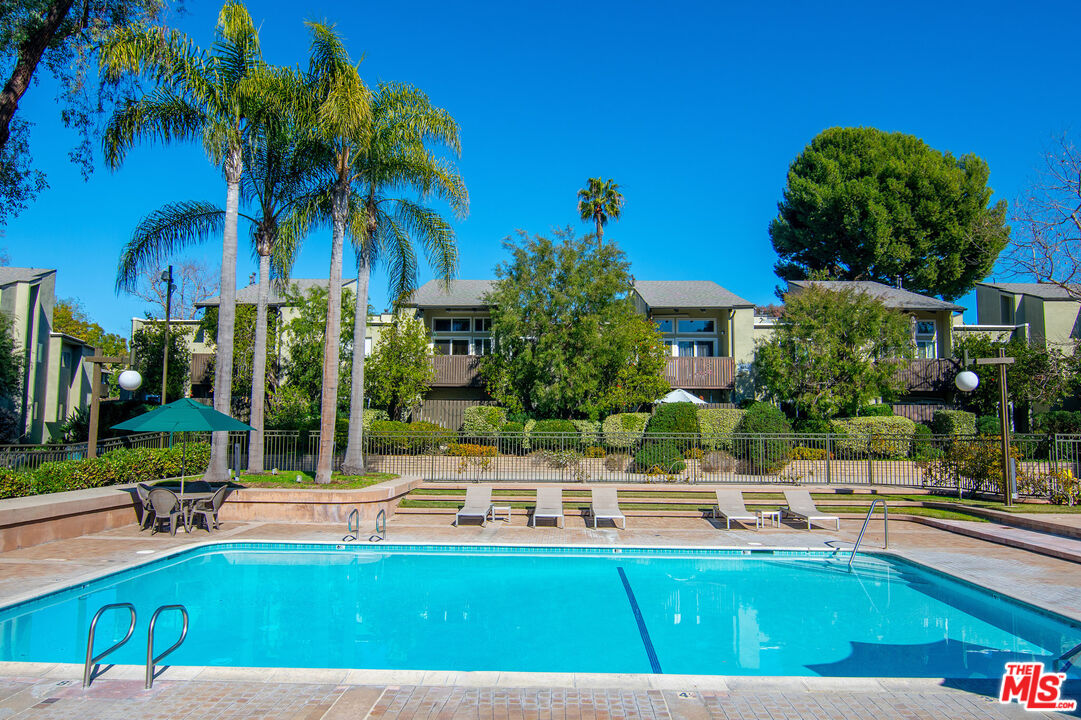 4925 Indian Wood Road, Unit 474 Culver City, CA 90230 - Photo 25 of 36 a swimming pool with outdoor seating and yard