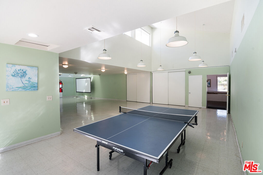 4925 Indian Wood Road, Unit 474 Culver City, CA 90230 - Photo 29 of 36 a room with pool table and a chandelier