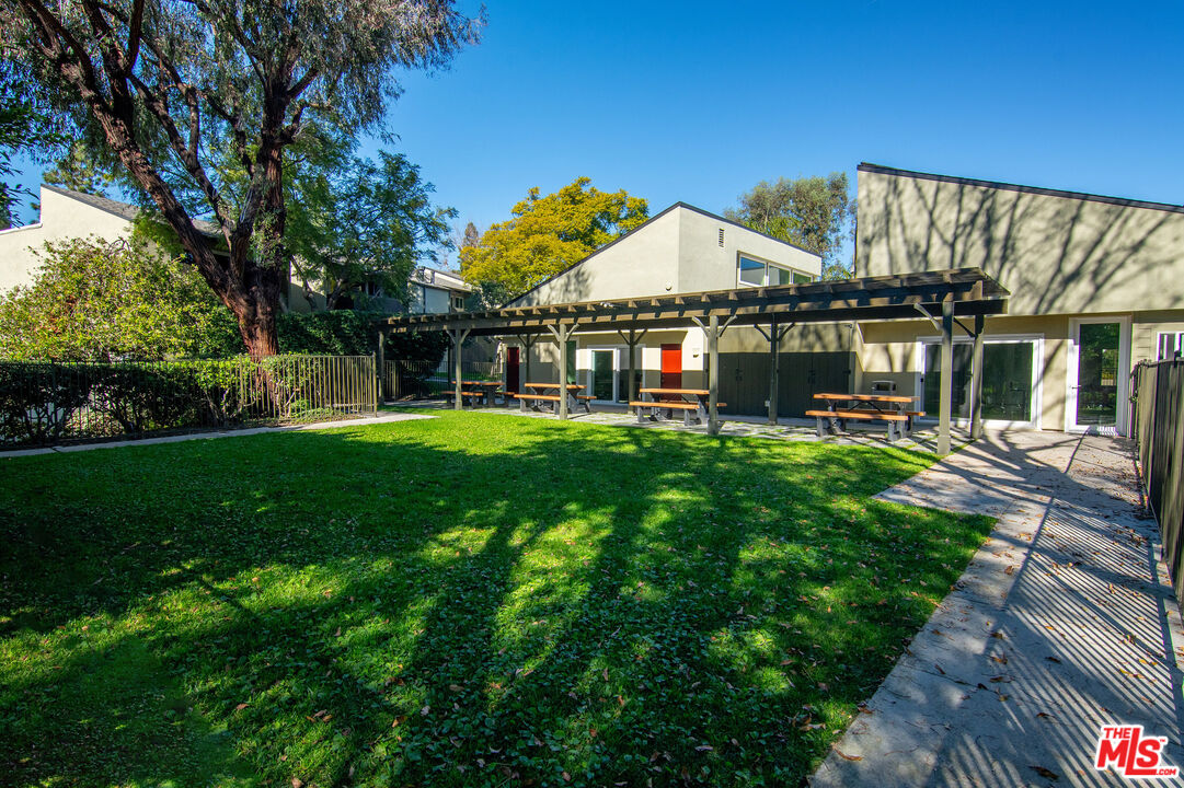 4925 Indian Wood Road, Unit 474 Culver City, CA 90230 - Photo 30 of 36 a view of a house next to a big yard and large trees
