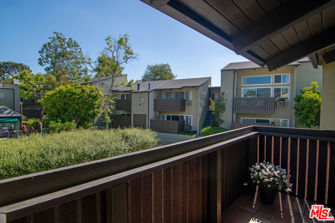 4925 Indian Wood Road, Unit 474 Culver City, CA 90230 - Photo 10 of 36 a balcony view with couple of flower garden in front of it