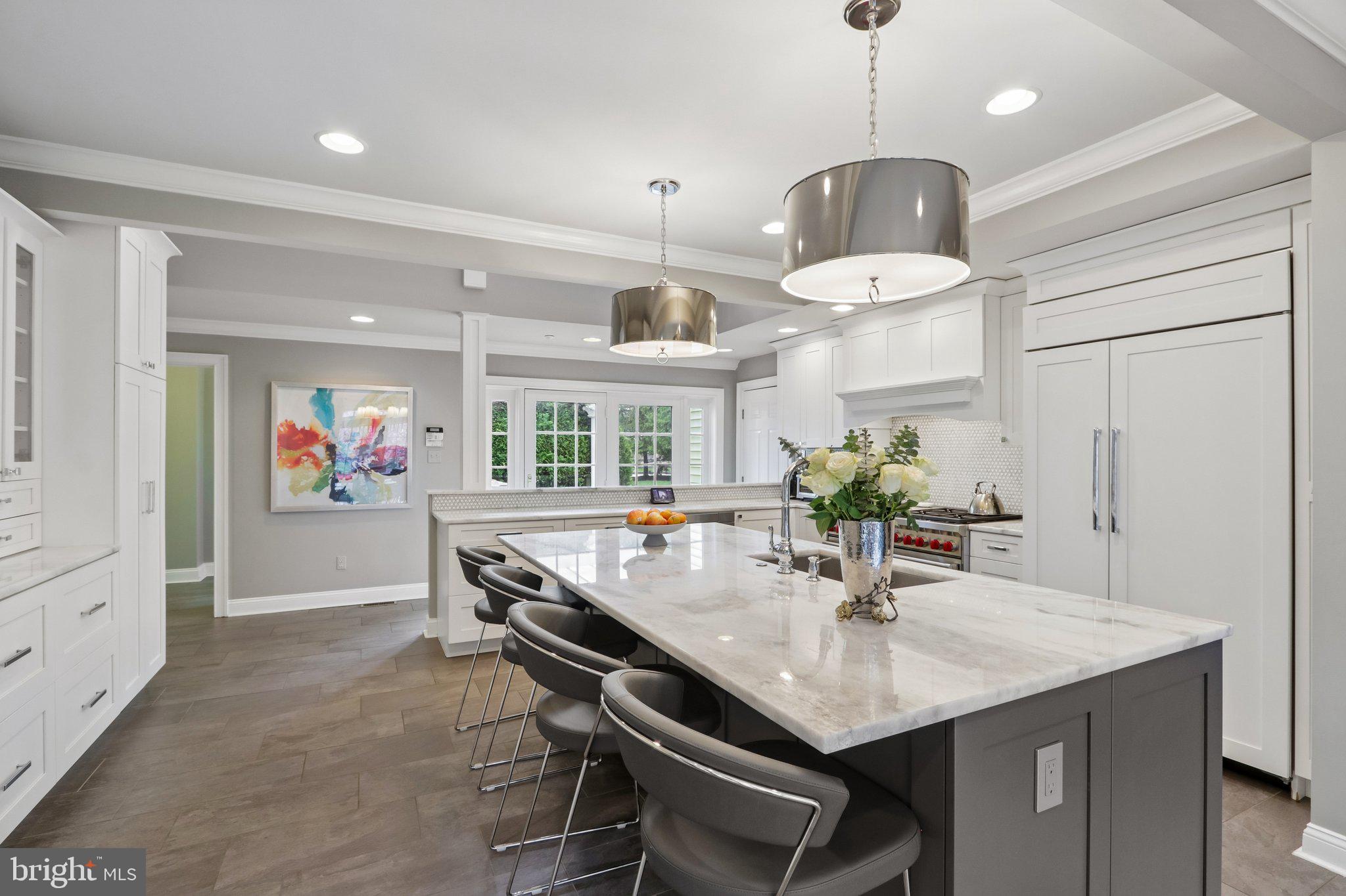 209 Welsh Road Ambler, PA 19002 - Photo 17 of 80 a kitchen with stainless steel appliances a dining table chairs and couches with white cabinets