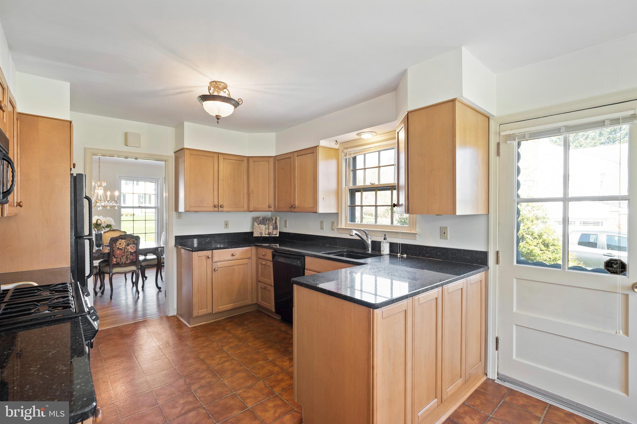 262 Coldstream Drive Berwyn, PA 19312 - Photo 6 of 45 a kitchen with granite countertop a sink a counter top space and living room area