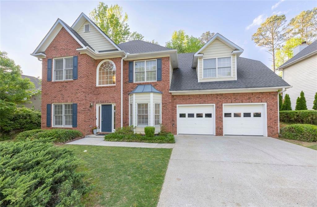 3145 Maple Terrace Drive Suwanee, GA 30024 - Photo 1 of 1 a front view of a house with a garden and plants