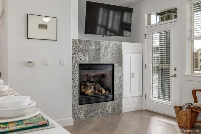 a living room with a fireplace and a flat screen tv