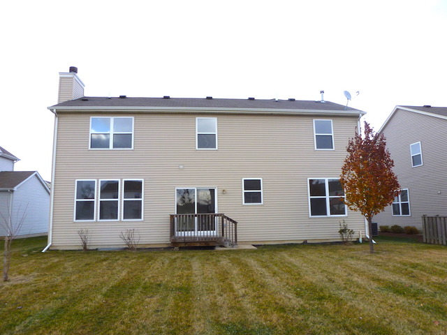 2873 Rourke Drive Aurora, IL 60503 - Photo 11 of 12 a view of a house with a yard and sitting space