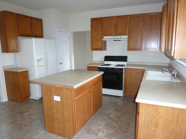 2873 Rourke Drive Aurora, IL 60503 - Photo 5 of 12 a kitchen with a stove top oven sink and cabinets