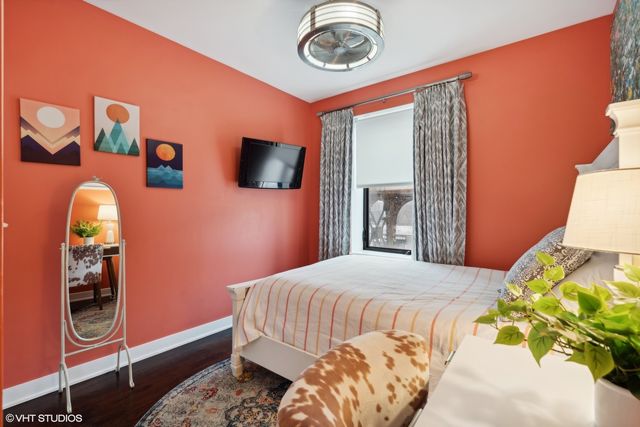 a bedroom with a bed and a flat screen tv