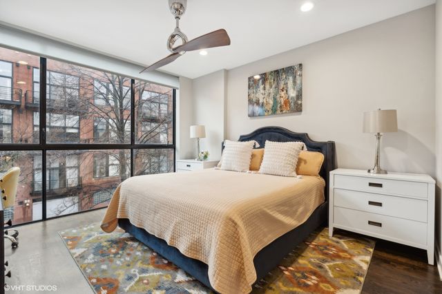 a bedroom with a large bed and a window