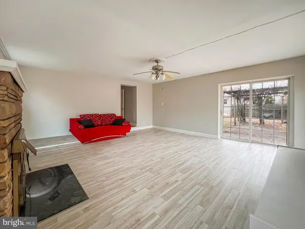 a room with wooden floor and white walls
