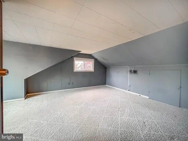 a view of an empty room with windows