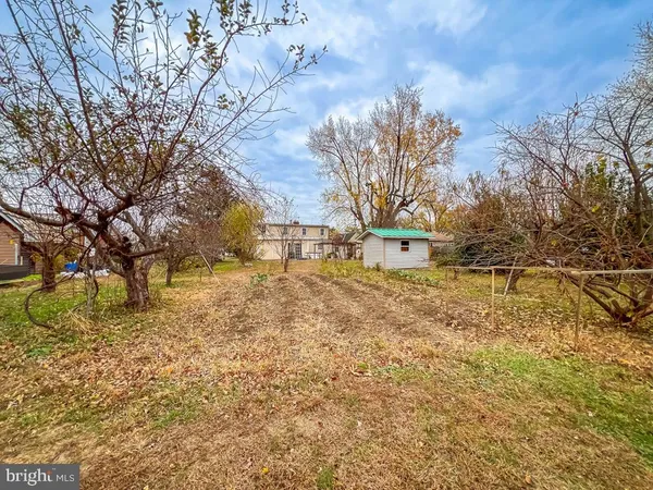 a front view of a house with a big yard