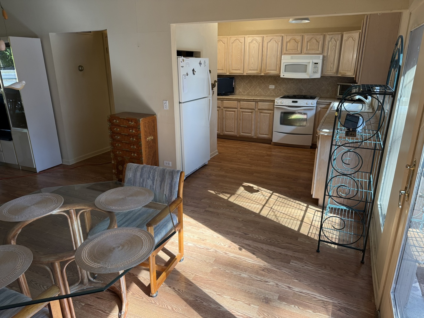 1901 West Plainfield Road La Grange Highlands, IL 60525 - Photo 13 of 37 a kitchen with stainless steel appliances granite countertop a refrigerator a stove a sink a dining table and chairs with wooden floor