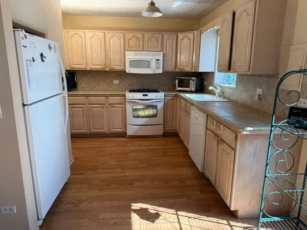 a kitchen with stainless steel appliances a refrigerator sink and cabinets