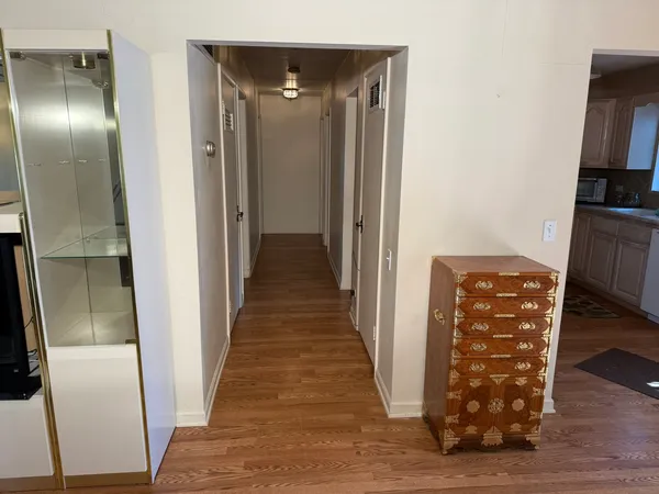a view of a hallway with wooden floor and staircase