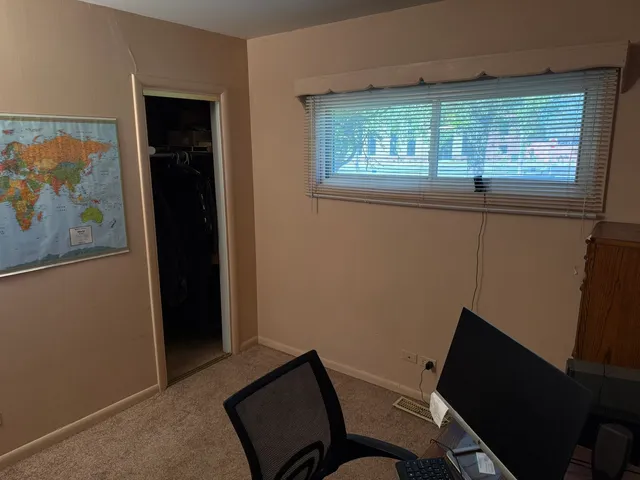 a view of a room with furniture and a window