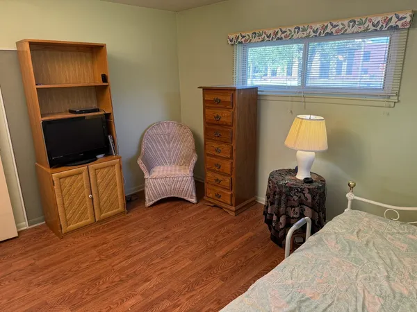 a bedroom with a bed and a chair in it