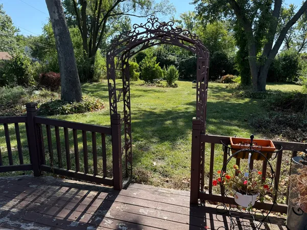 a view of a porch with chairs and backyard