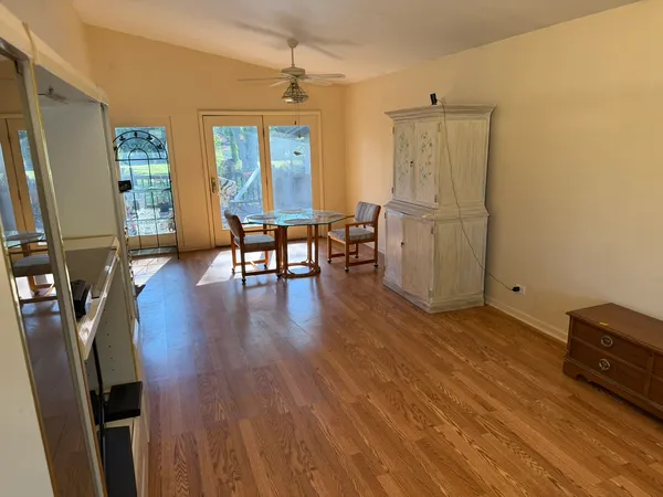 a view of a workspace with furniture and wooden floor