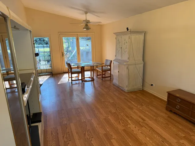 a view of a workspace with furniture and wooden floor