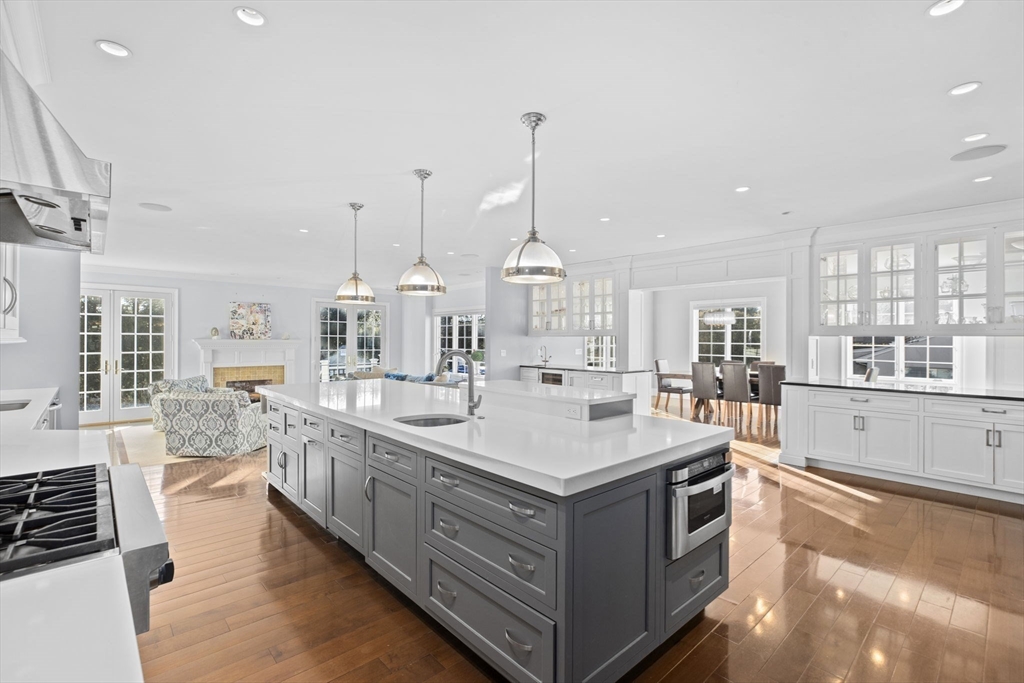 37 Columbine Road Newton, MA 02459 - Photo 8 of 40 a large kitchen with kitchen island a sink stove and wooden floor