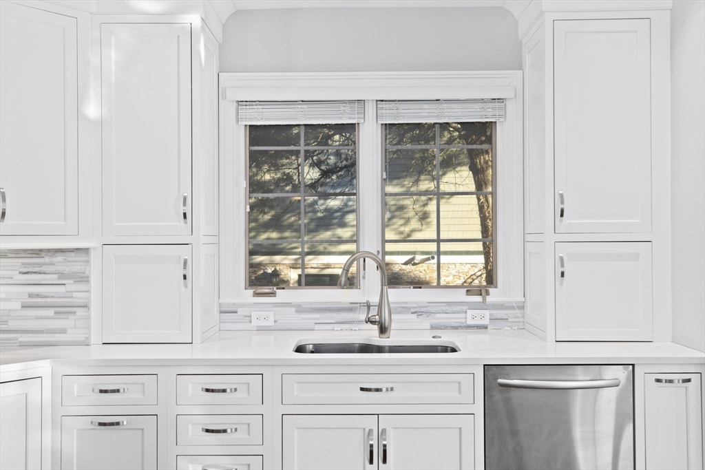 37 Columbine Road Newton, MA 02459 - Photo 10 of 40 a kitchen with granite countertop white cabinets and a window
